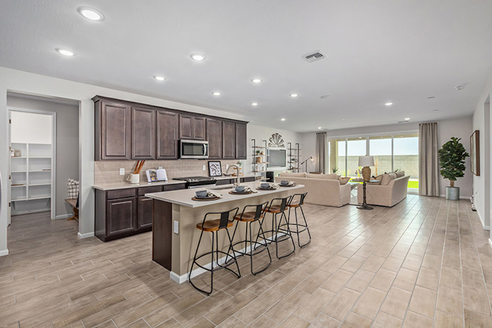 A large kitchen with a dining table.