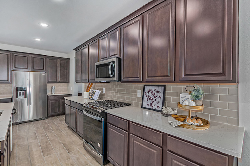 A kitchen with wooden cabinets.