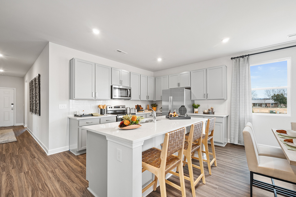 A kitchen with white cabinets.