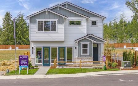 A white house with blue doors.