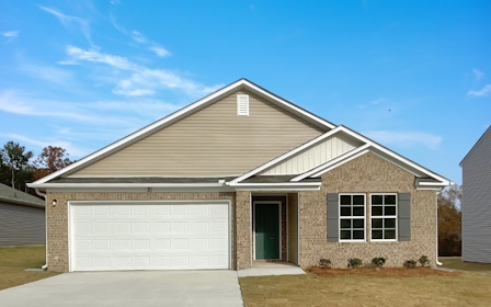 A house with a garage with American Gothic House in the background.