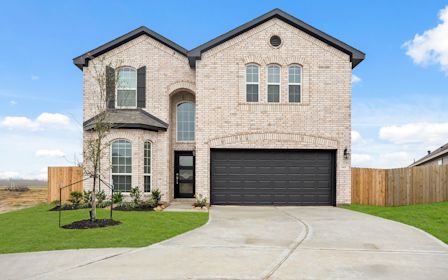A large brick building with a garage.