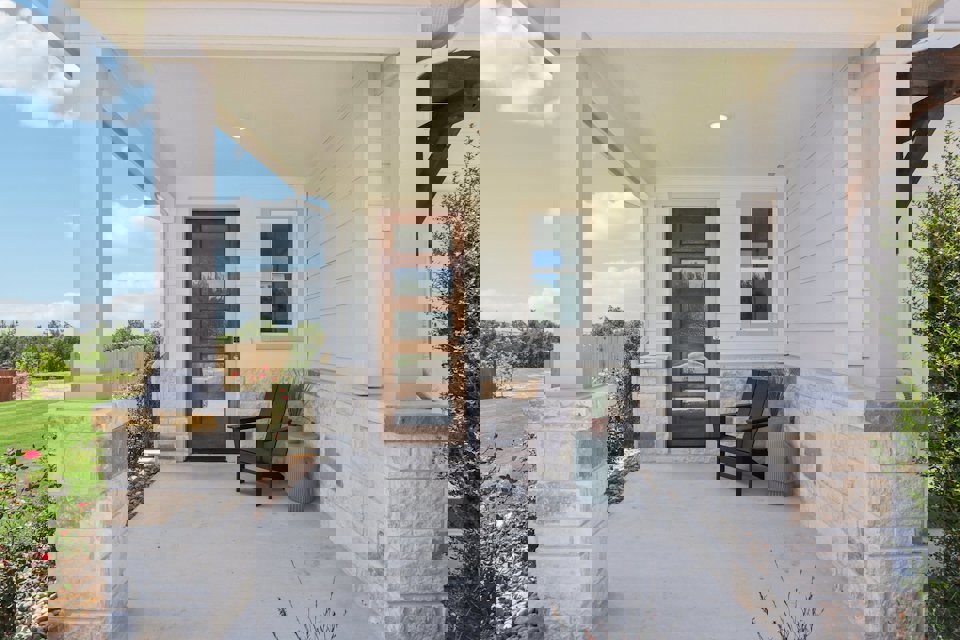 A bench in front of a house.