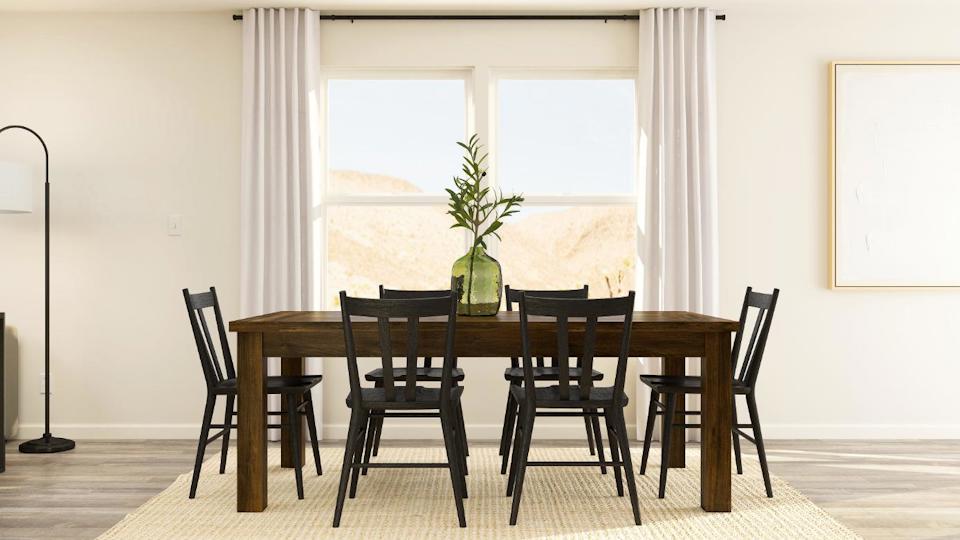 A dining table with chairs around it.