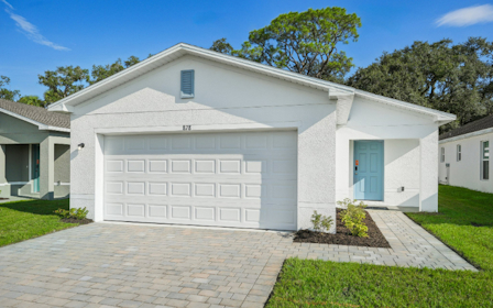 A white house with a driveway.
