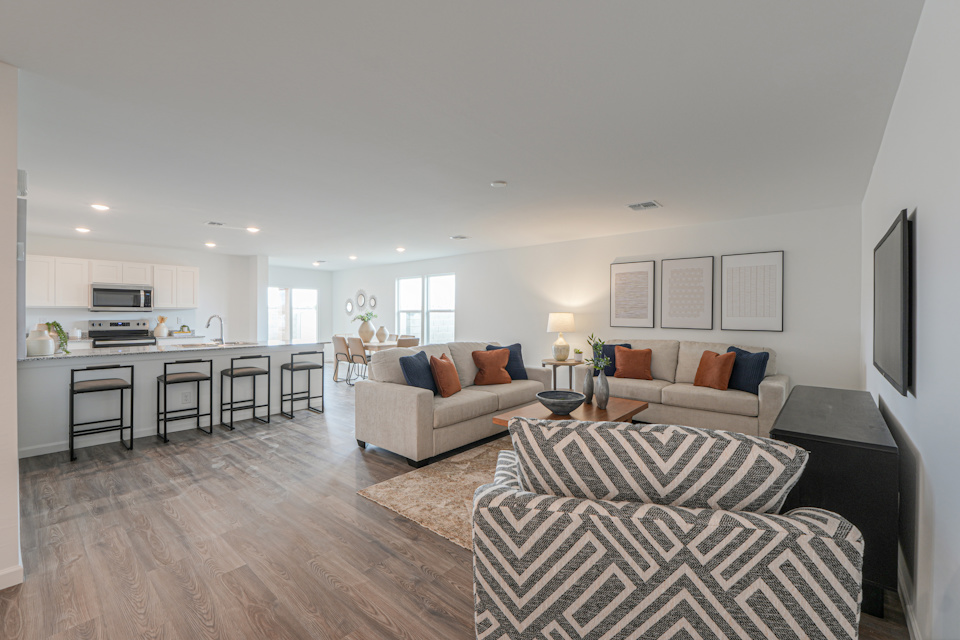 A living room with a large kitchen.