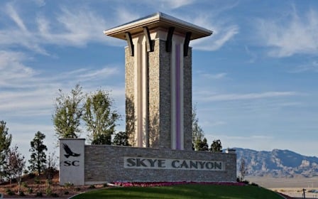 A sign on a stone wall.