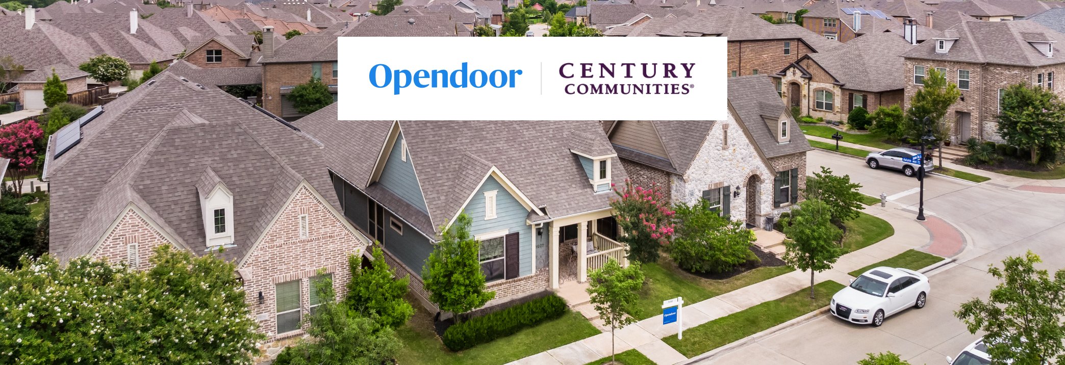 A street with houses and cars.