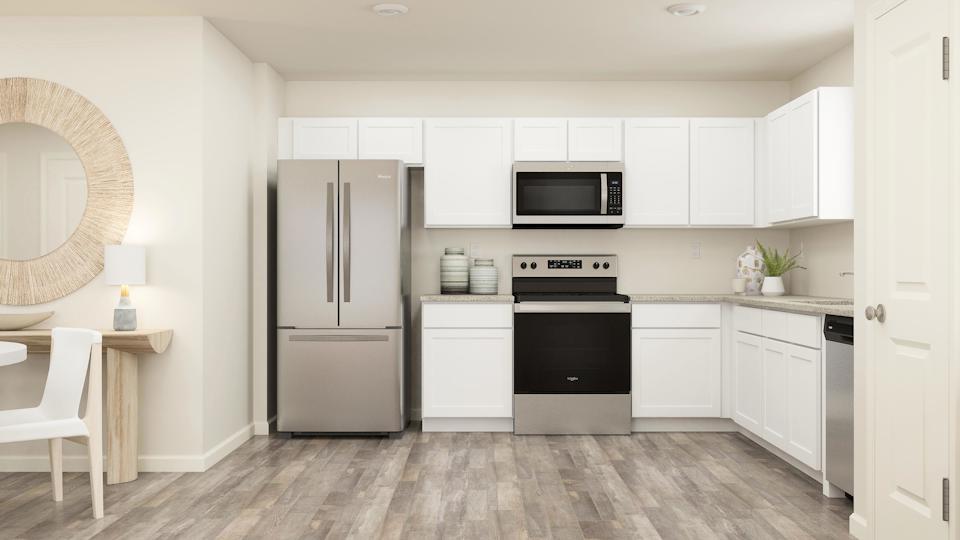 White cabinets and granite countertops in the kitchen.