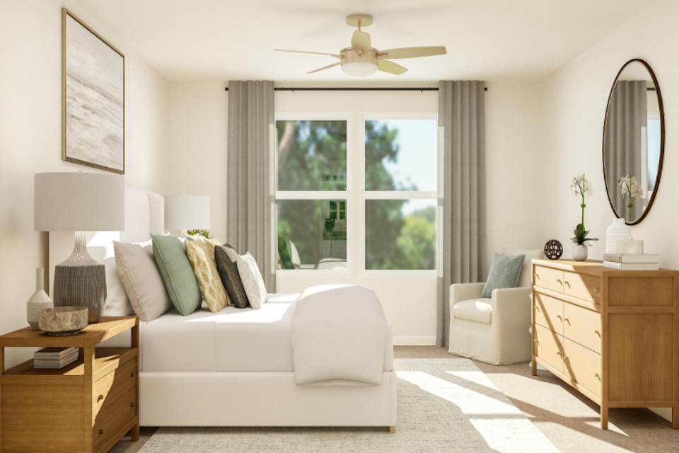 A living room with a white couch and a white chair.