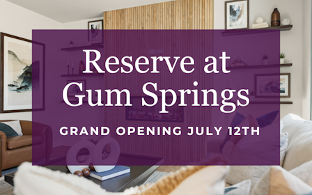 A room with a couch and a table with a book on it.