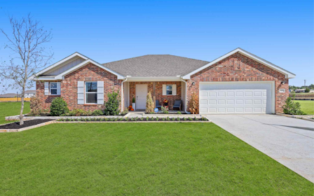 A brick house with a lawn.